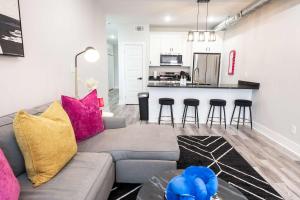 a living room with a couch and a kitchen at Mid City Magic 5 in New Orleans +60 photos