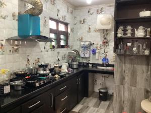 una cucina con lavello e fornello forno superiore di VisitingVillah a Srinagar