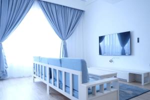 a baby room with a crib and a tv at Tung Kidcove Centrum Cameron in Brinchang