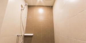 a bathroom with a shower with a shower head at Cozy apartment near Don Mueang airport in Lak Si