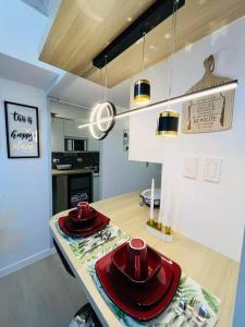 a kitchen with a table with red hats on it at KLM Cityscape in San Fernando
