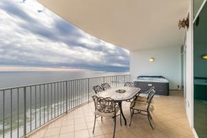 a balcony with a table and chairs and the ocean at Turquoise Place 2205 C in Orange Beach +45 photos