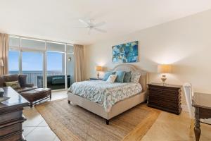 a bedroom with a bed and a desk and a couch at Turquoise Place 2205 C in Orange Beach
