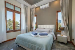 a bedroom with a bed with towels on it at The garden pool villa resort at Doi Saket in Ban Muang Wa +237 photos