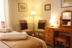 Uma cama ou camas num quarto em Willance House Guest House