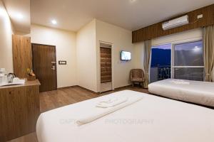 מיטה או מיטות בחדר ב-Hotel Dashain
