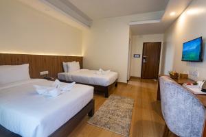 מיטה או מיטות בחדר ב-Hotel Dashain
