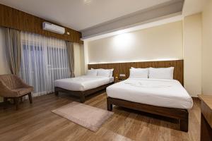 מיטה או מיטות בחדר ב-Hotel Dashain
