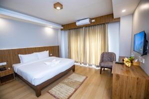 מיטה או מיטות בחדר ב-Hotel Dashain