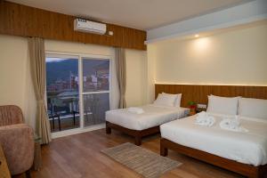 מיטה או מיטות בחדר ב-Hotel Dashain