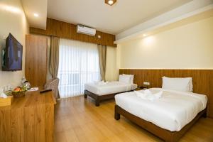 מיטה או מיטות בחדר ב-Hotel Dashain