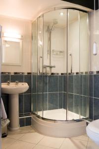 a bathroom with a shower and a sink at Willance House Guest House in Richmond