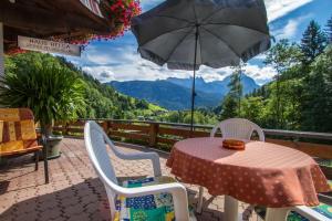 a table and chairs with an umbrella on a patio at Haus Helga in Unken