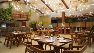 a dining room with wooden tables and chairs at The Zen Villas Resort in Lipa