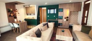 a living room with a couch and a table at Pine apartment Vlašić in Vlasic