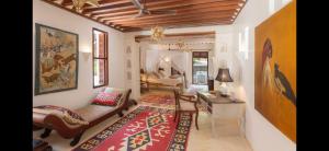 a living room with a couch and a table at Dhow House in Shela