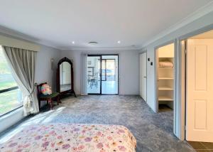 a bedroom with a bed and a mirror at Cozy on north in Armidale