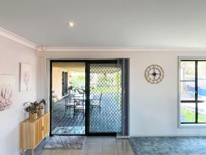a pivot door in a home with a dining room at Cozy on north in Armidale +19 photos