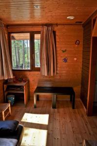 Habitación con banco en una cabaña de madera en Camping Caravaning Cuenca, en Cuenca