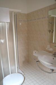 a bathroom with a shower and a sink and a toilet at Hotel Arlecchino in Milano Marittima