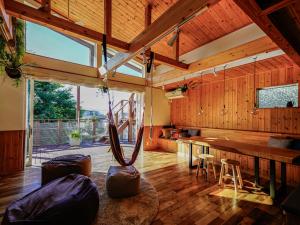 a large room with wooden walls and a large window at Kamiya Cottage in Hayama