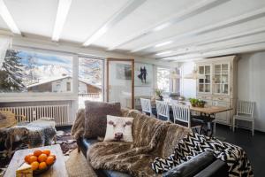 a living room with a couch and a table at Apartment Corbassière 24 in Verbier