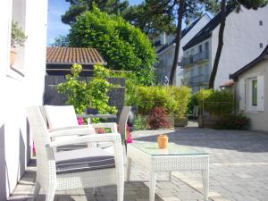 a patio with two chairs and a table at Hotel Mona Lisa in La Baule