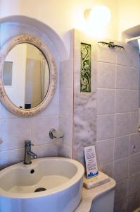 a bathroom with a sink and a mirror on the wall at Villa Pinelopi in Mikonos