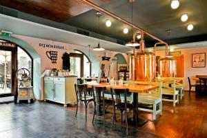 a restaurant with a table and chairs and a kitchen at Hotel Restaurant Darwin in Prague +27 photos