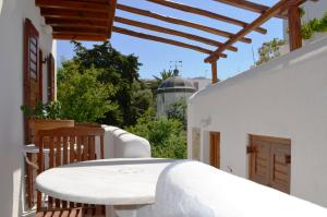 a white table and chairs on a balcony at Villa Pinelopi in Mýkonos City