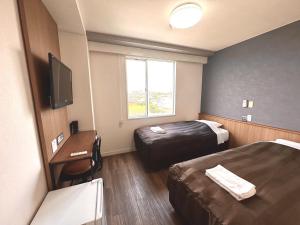 Postel nebo postele na pokoji v ubytování Tabist Tsukuba Sky Hotel + 22 fotografií