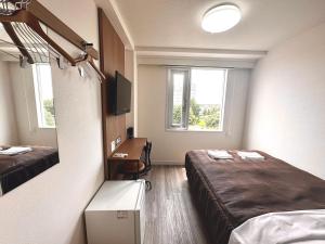 Postel nebo postele na pokoji v ubytování Tabist Tsukuba Sky Hotel