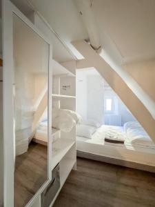 a bedroom with a bunk bed and a mirror at Luna in Caen