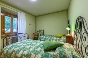Postel nebo postele na pokoji v ubytování Il Gugnolo - Casale in Val d'Orcia