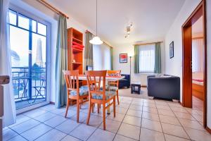 a living room with a dining room table and chairs at Fishermans in Borkum