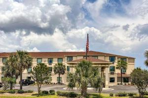 a hotel with an american flag in front of it at Comfort Inn & Suites Panama City North in Panama City