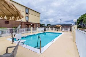 a swimming pool at a hotel with chairs around it at Comfort Inn & Suites Panama City North in Panama City