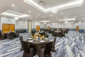a banquet room with tables and chairs and chandeliers at Comfort Suites Ogden Conference Center in Ogden +62 photos