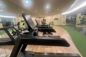 a gym with treadmills and elliptical machines at Shore2 Haven - Chic Condotel Near Mall of Asia in Manila