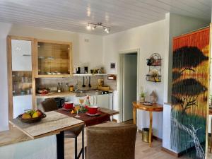 a kitchen with a table and a dining room at Ferienwohnung Altes Zollhaus in Ering