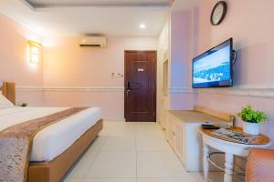 Postel nebo postele na pokoji v ubytování Fortune 1127 - Central Hotel