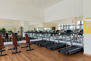 a gym with a row of treadmills and chairs at Good Choice and Comfy 2BR Sky House BSD Apartment By Travelio in Tangerang