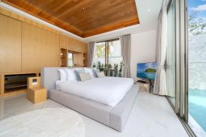 une chambre avec un grand lit et une télévision dans l'établissement New Elegance & Tropical Luxury - 4BR Pool Villa in Lux Pride 2 V8 Residence, near Laguna, à Ban Pak Lak 25 autres photos