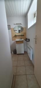 a small kitchen with a sink and a tiled floor at studio 2 pers Fromentine centre in La Barre-de-Monts +5 photos