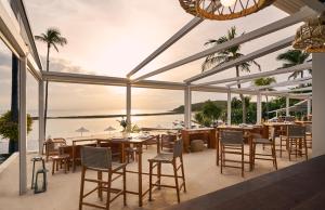 a restaurant with tables and chairs and a view of the ocean at Anantara Lawana Koh Samui Resort in Chaweng