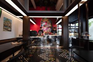 a restaurant with a large painting on the wall at Anantara Lawana Koh Samui Resort in Chaweng