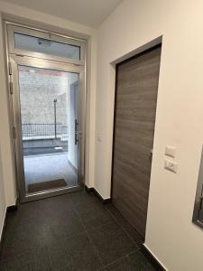a door leading to a hallway with a glass door at HilMar Holiday Home in SantʼAgata di Militello
