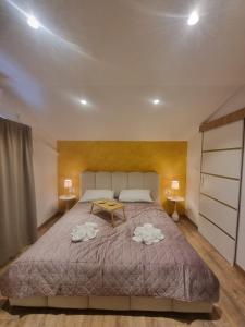 a bedroom with a large bed with two towels on it at Apartment Niko in Senj