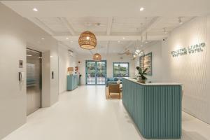 a corridor of a hospital with a reception desk in a lobby at Coastal Living Hotel Phu Quoc - Free Ticket Cable Car & Hon Thom Water Park in Phu Quoc