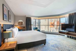 a hotel room with a bed and a large window at Wyndham Wroclaw Old Town in Wrocław